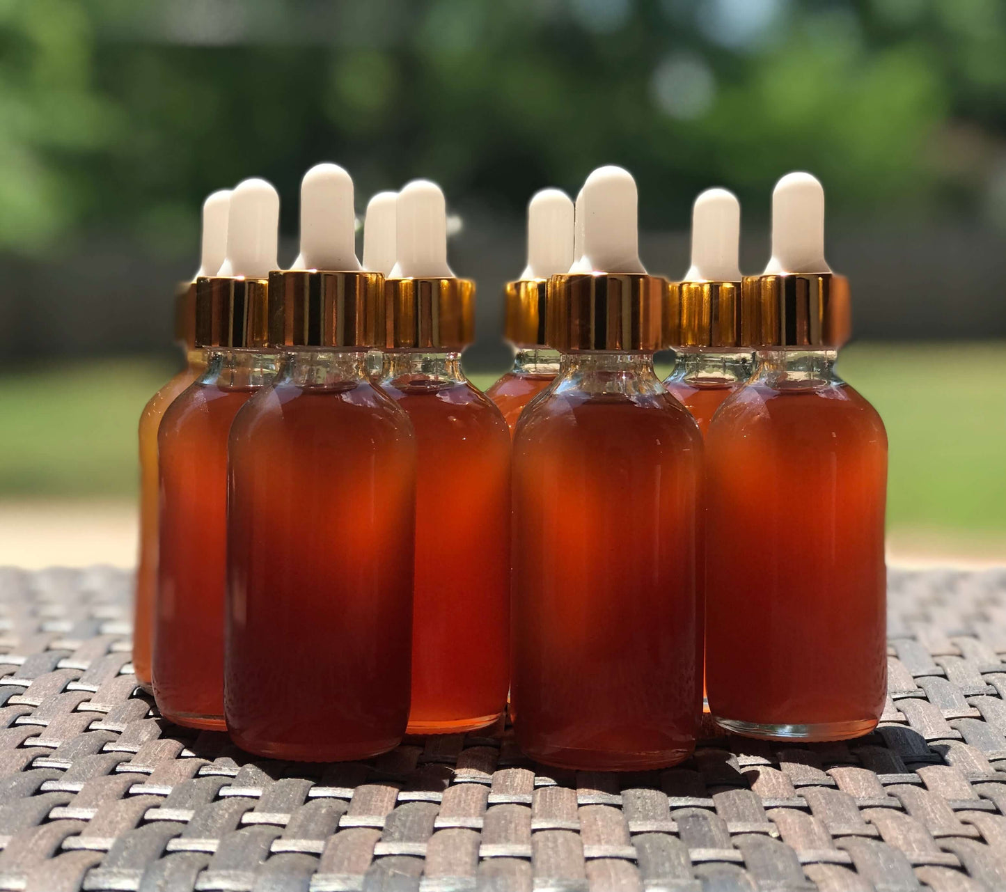 herbal hair growth oil outside on a table with no label